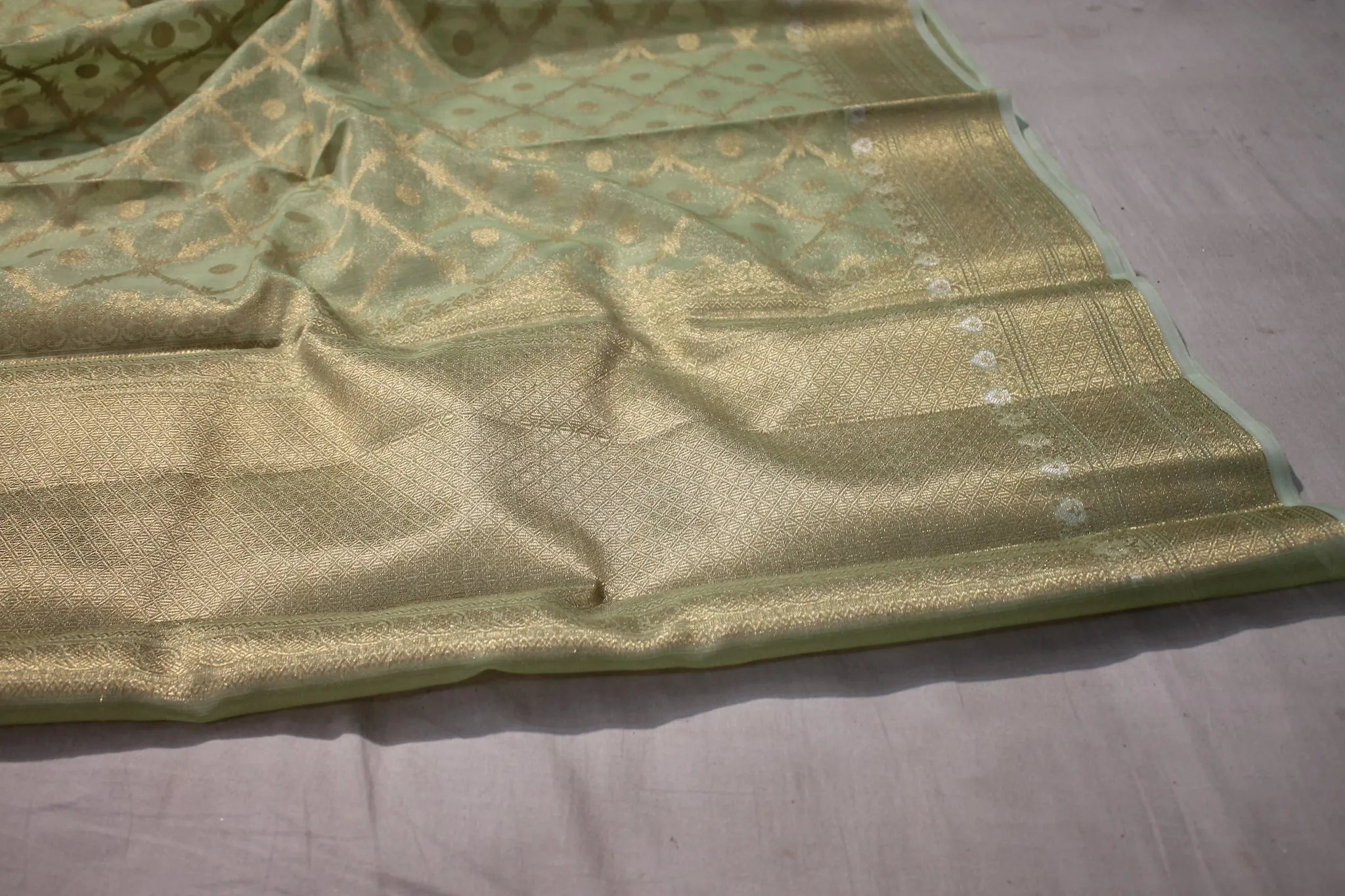 Elegance of Pastel Green Pure Tissue Silk Saree with Gold Jaal Work